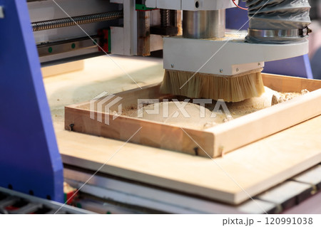 close up of CNC router machine carving wood close up of CNC router machine carving wood 120991038