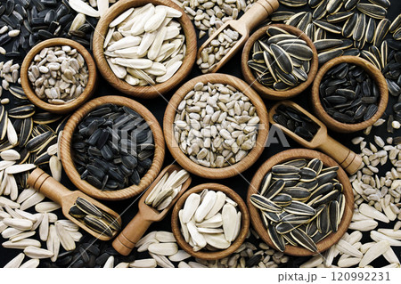 Varieties of sunflower seeds and dehulled kernels, food ingredients, healthy snacks Varieties of sunflower seeds and dehulled kernels, food ingredients, healthy snacks 120992231