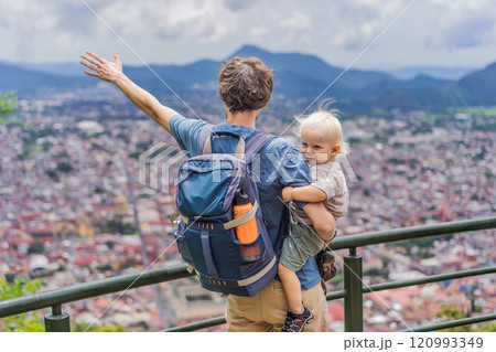 Dad and his baby son tourists in front of the panoramic view of Orizaba from Cerro del Borrego, Mexico. Travel, scenic landscape, and adventure concept 120993349