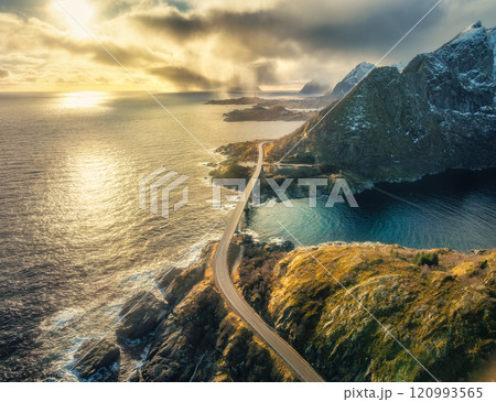Aerial view of bridge crossing the fjord with snowy mountains Aerial view of bridge crossing the fjord with snowy mountains 120993565
