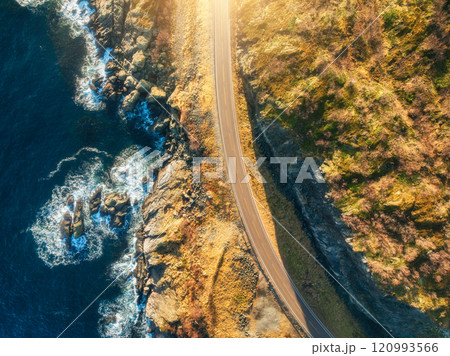 Aerial view of winding coastal road, cliffs and sea with waves Aerial view of winding coastal road, cliffs and sea with waves 120993566