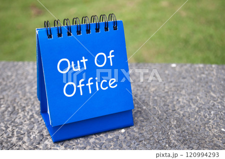 Side view of Out Of Office text on blue notepad. Off work concept Side view of Out Of Office text on blue notepad. Off work concept 120994293