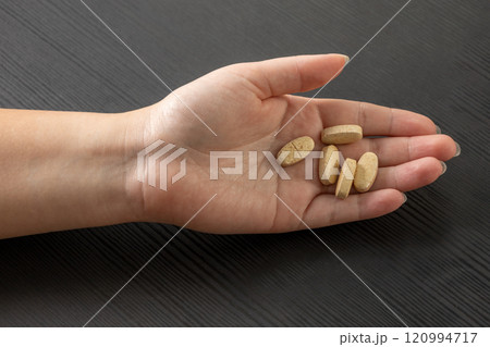 Tablets in a woman hand isolated on white background 120994717