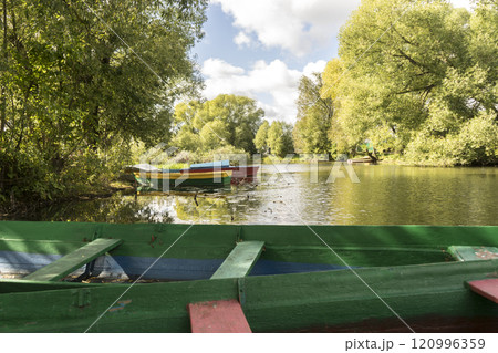 Rowing boat floating over the Lake. Fishing lake in early summer. Rowing boat floating over the Lake. Fishing lake in early summer. 120996359