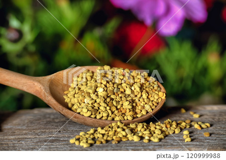 Wooden Spoon Filled with Bee Pollen in a Natural Setting Wooden Spoon Filled with Bee Pollen in a Natural Setting 120999988