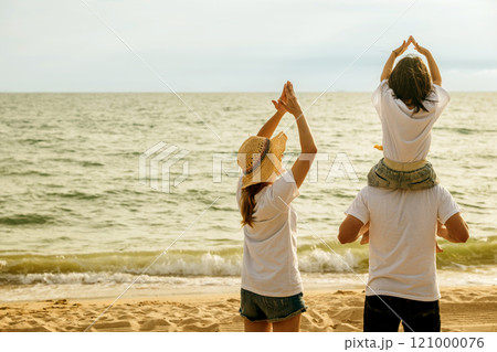 Happy family in holiday. Father, Mother and kids having fun together shoulder ride on summer beach, Parents carrying children on neck at beach, family is enjoying their summer in sunset time Happy family in holiday. Father, Mother and kids having fun together shoulder ride on summer beach, Parents carrying children on neck at beach, family is enjoying their summer in sunset time 121000076