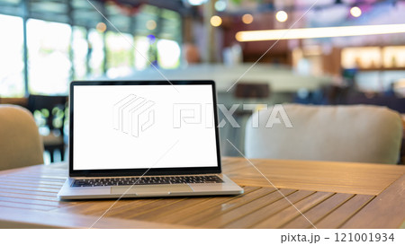 Laptop with blank screen and placed on a wooden table inside a coffee shop. Workspace background new project on laptop computer with blank copy space screen for your advertising text message. 121001934