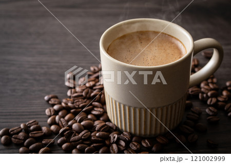 テーブルの上のカフェラテとコーヒー豆 121002999