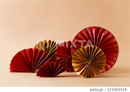 Chinese new year festival decorations with red Chinese folded fans on soft orange color background. Chinese new year festival decorations with red Chinese folded fans on soft orange color background. 121003529