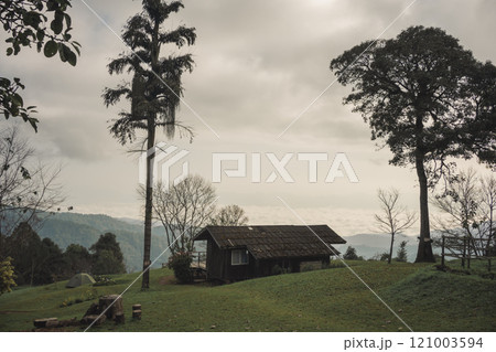 landscape and travel concept with sunrise and layer of mountain and mist with country house 121003594
