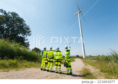 Team of electrical engineer is perform the inspection and maintenance of electric generating windmill turbine. Team of electrical engineer is perform the inspection and maintenance of electric generating windmill turbine. 121003877