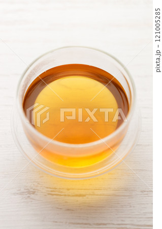 Cup of hot tea blended from rooibos, spearmint, apple, baobab on white wooden table. 121005285