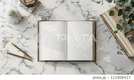 An open book with white pages on a marble surface, with stationery elements nearby An open book with white pages on a marble surface, with stationery elements nearby 121006417