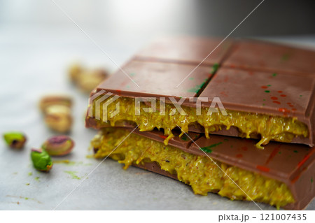 Trend Dubai chocolate with pistachio paste and kataifi dough. Confectionery handmade sweets at home in the kitchen.  121007435