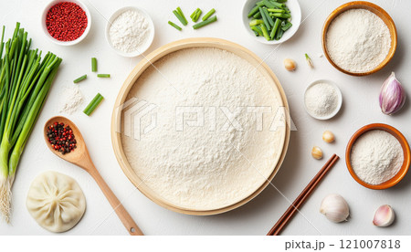 Fresh ingredients for dumplings, including flour, scallions, and garlic 121007818