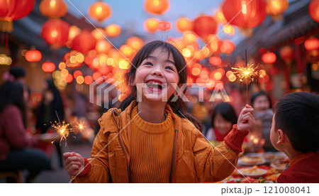 joyful girl holding sparklers at festive celebration with lanterns joyful girl holding sparklers at festive celebration with lanterns 121008041