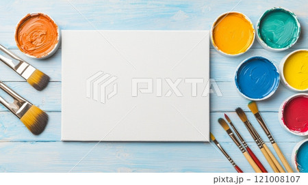 Art supplies with paint and canvas on a wooden table, bright and colorful setup. Art supplies with paint and canvas on a wooden table, bright and colorful setup. 121008107