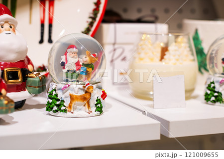 A beautifully crafted snow globe featuring Santa Claus and reindeer inside of it 121009655