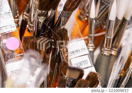 A collection of various makeup brushes neatly organized in a clear container A collection of various makeup brushes neatly organized in a clear container 121009657