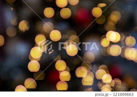 A softly blurred image showcasing beautiful Christmas lights adorning a tree A softly blurred image showcasing beautiful Christmas lights adorning a tree 121009663