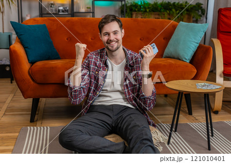 Winner man holds smartphone reads good news amazed by online bet bid game lottery jackpot casino win Winner man holds smartphone reads good news amazed by online bet bid game lottery jackpot casino win 121010401