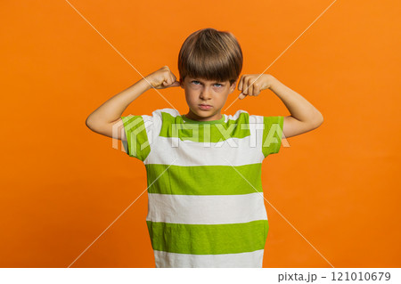 Fit sporty child boy kid showing biceps and looking healthy, feeling power strength success win 121010679