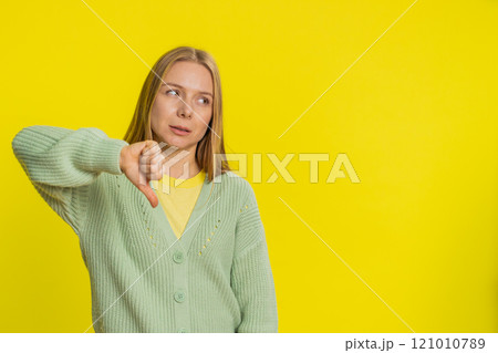 Upset woman girl showing thumbs down gesture disapproval dissatisfied dislike negative feedback Upset woman girl showing thumbs down gesture disapproval dissatisfied dislike negative feedback 121010789