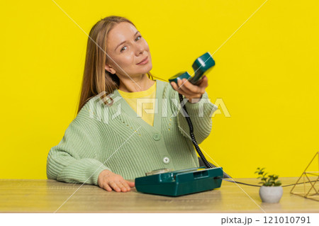 Woman advertising phone call having conversation on wired retro telephone helpline hotline support Woman advertising phone call having conversation on wired retro telephone helpline hotline support 121010791