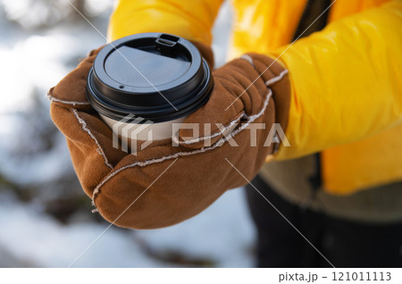 coffee in woman hands. to go Disposable paper cup closeup. Delicious hot beverage Glogg drink street 121011113
