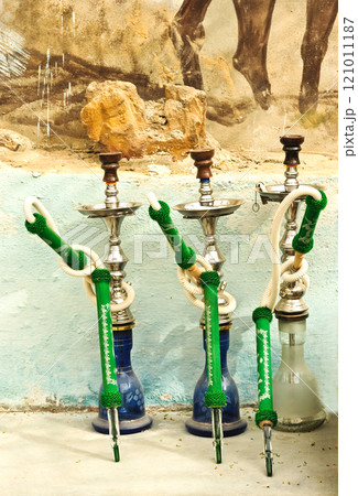 Hookah standing on the ground, on the street, outdoors. Concept of bad habits, unhealthy lifestyle. 121011187