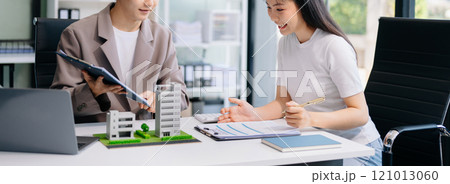 Balancing the property sector The real estate agent is explaining the house style to see the house design and the purchase agreement. model house 121013060