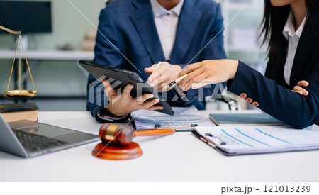 Two lawyers are discussing about contract paper, law matters determination, pointing.law and hammer 121013239