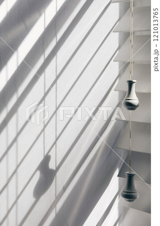 Close-up of white window blinds and shadows 121013765
