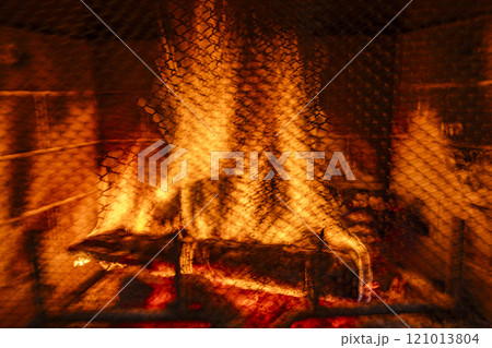 Close-up of fire burning in fireplace, blurred motion Close-up of fire burning in fireplace, blurred motion 121013804