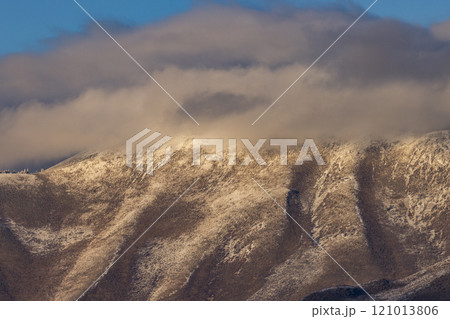 Low clouds covering foothills in snow  121013806