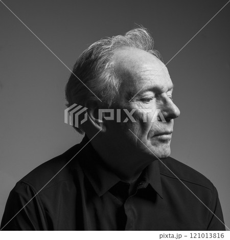 Studio portrait of serious senior man in black shirt, black and white Studio portrait of serious senior man in black shirt, black and white 121013816