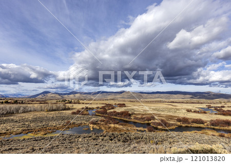 Clouds over wetlands and hills in distance at Silver Creek Preserve 121013820
