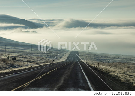 Clouds and fog over empty Idaho 20 road 121013830