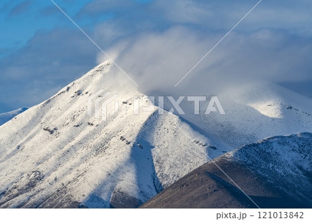Snowy hills obscured with low cloud 121013842