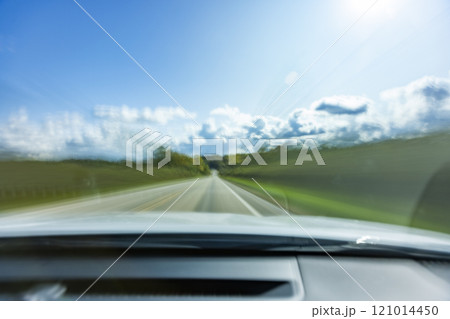 USA, Wisconsin, Country road and clouds seen from moving car 121014450