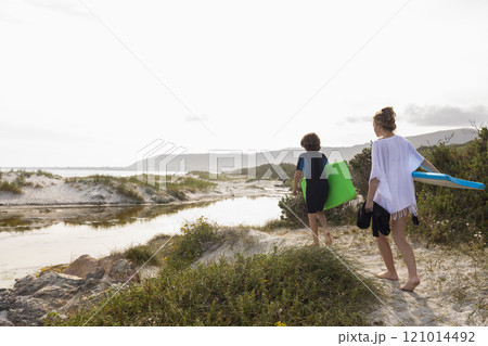 South Africa, Hermanus, Brother and sister walking on beach with body boards South Africa, Hermanus, Brother and sister walking on beach with body boards 121014492