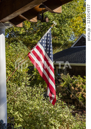 American flag outside house in sunlight American flag outside house in sunlight 121014557