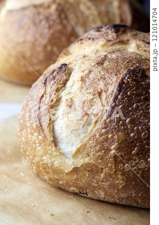Close-up of sourdough bread on parchment paper Close-up of sourdough bread on parchment paper 121014704