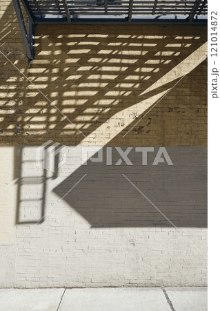 Shadows on concrete and brick wall 121014872