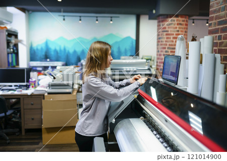 Woman working in printing studio Woman working in printing studio 121014900