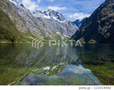 Calm lake and mountains in Fiordland National Park 121014992