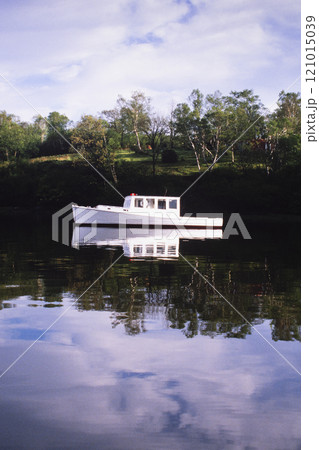 White lobster boat anchored in calm harbor 121015039