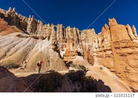 Woman taking pictures in Bryce Canyon National Park 121015117