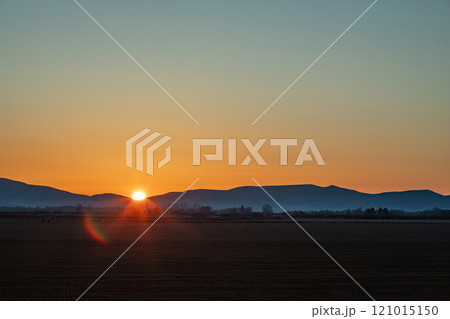 Sun setting behind hills near Sun Valley 121015150