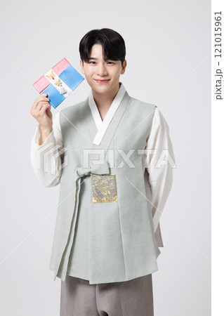 Portrait of a young man wearing hanbok and holding a luxury gift certificate Portrait of a young man wearing hanbok and holding a luxury gift certificate 121015961